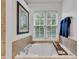 Close-up of bright bathtub and tiled surround with window view and towel rack at 8973 Carnation Dr, Noblesville, IN 46060