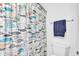 Bright bathroom with a whimsical fish patterned shower curtain and modern fixtures at 8973 Carnation Dr, Noblesville, IN 46060