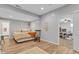 View of bedroom featuring wood-look flooring, neutral paint, and a comfy bed with a decorative rocking chair at 8973 Carnation Dr, Noblesville, IN 46060
