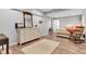 View of bedroom featuring wood-look flooring, neutral paint, comfy bed, rocking chair and vintage Victrola on dresser at 8973 Carnation Dr, Noblesville, IN 46060