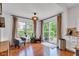 Cozy breakfast nook featuring hardwood floors, large windows, neutral curtains, and access to the patio at 8973 Carnation Dr, Noblesville, IN 46060