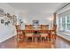 Elegant dining room with a large table, wood floors, crown molding, and a window seat at 8973 Carnation Dr, Noblesville, IN 46060