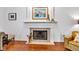 Close up of a fireplace with white mantle and hearth in a well lit living room at 8973 Carnation Dr, Noblesville, IN 46060
