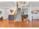 Spacious foyer showcasing hardwood floors, an open staircase, and views into the adjacent living areas at 8973 Carnation Dr, Noblesville, IN 46060
