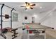 Finished basement game room featuring a ceiling fan, ping pong table, pull up bar, and stairs at 8973 Carnation Dr, Noblesville, IN 46060
