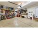 A garage with high ceilings, overhead storage racks, peg boards and plenty of shelving at 8973 Carnation Dr, Noblesville, IN 46060