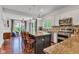 Open kitchen featuring a large island with seating, modern appliances, and bright lighting at 8973 Carnation Dr, Noblesville, IN 46060