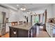 Kitchen island with granite countertops, cabinets, and pendant lighting with view to the breakfast nook at 8973 Carnation Dr, Noblesville, IN 46060