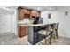 Finished basement kitchenette featuring cherry cabinets, a wine rack, and breakfast bar at 8973 Carnation Dr, Noblesville, IN 46060