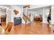 Spacious living room with staircase, wood floors, and view of the formal dining room at 8973 Carnation Dr, Noblesville, IN 46060