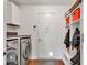 Convenient mud room featuring a washer, dryer, storage cabinets, and a door to the outside at 8973 Carnation Dr, Noblesville, IN 46060