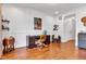 Well-lit office area with a wooden desk and chair, complemented by wall art and shelves at 8973 Carnation Dr, Noblesville, IN 46060