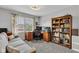 Bright home office with large window, desk setup, and built-in bookcase for optimal organization at 8973 Carnation Dr, Noblesville, IN 46060