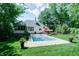 Backyard view of the in-ground pool with backyard and tree surround at 9154 Sargent Manor Ct, Indianapolis, IN 46256