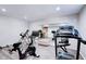 Bright basement gym with modern exercise equipment, mirrors, and great lighting at 9154 Sargent Manor Ct, Indianapolis, IN 46256