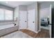 A bright main bathroom featuring a soaking tub and linen closets at 9154 Sargent Manor Ct, Indianapolis, IN 46256