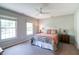 Cozy bedroom with a ceiling fan, two bright windows, and neutral colors at 9154 Sargent Manor Ct, Indianapolis, IN 46256