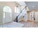 Elegant foyer boasts high ceilings, grand staircase, and stylish light fixture, creating a welcoming atmosphere at 9154 Sargent Manor Ct, Indianapolis, IN 46256