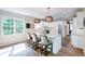 Bright kitchen features white cabinets, stainless appliances, island with bar seating, and decorative lighting at 9154 Sargent Manor Ct, Indianapolis, IN 46256