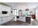 Bright kitchen boasts stainless appliances, white cabinetry, an island with seating, and modern pendant lighting at 9154 Sargent Manor Ct, Indianapolis, IN 46256