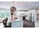 Modern kitchen with stainless steel appliances, marble countertops, a stylish island, and natural lighting at 9154 Sargent Manor Ct, Indianapolis, IN 46256