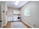 Well-lit laundry room with new appliances and ample cabinet space at 9154 Sargent Manor Ct, Indianapolis, IN 46256