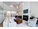 Bright, open living room with fireplace, vaulted ceiling, and open view into entry and staircase at 9154 Sargent Manor Ct, Indianapolis, IN 46256