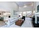 Spacious living room open to the kitchen featuring hardwood floors, and modern decor with fireplace at 9154 Sargent Manor Ct, Indianapolis, IN 46256