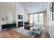Spacious living room with vaulted ceiling, fireplace, large windows, and stylish decor and furnishings at 9154 Sargent Manor Ct, Indianapolis, IN 46256