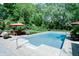 An in-ground pool features a patio area and a green lawn, perfect for summer relaxation at 9154 Sargent Manor Ct, Indianapolis, IN 46256