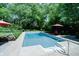 A landscaped backyard features an in-ground pool, patio, and manicured garden at 9154 Sargent Manor Ct, Indianapolis, IN 46256