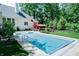 A backyard showcases an in-ground pool, lush landscaping, and a well-maintained lawn at 9154 Sargent Manor Ct, Indianapolis, IN 46256