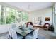 Light-filled sunroom featuring large windows, a dining table with seating, and additional lounge furniture at 9154 Sargent Manor Ct, Indianapolis, IN 46256