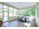 Bright sunroom features large windows, a dining table with seating, and access to the outdoors at 9154 Sargent Manor Ct, Indianapolis, IN 46256