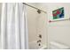 Clean bathroom featuring a shower with white subway tile and a white shower curtain at 1015 N Beville Ave, Indianapolis, IN 46201