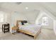 Cozy bedroom featuring natural light from an attic window and an ensuite bathroom and changing table at 1015 N Beville Ave, Indianapolis, IN 46201