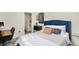 Comfortable bedroom showcasing a blue headboard and neutral bedding at 1015 N Beville Ave, Indianapolis, IN 46201