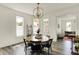 Bright dining room with a wooden table, chandelier, and hardwood floors at 1015 N Beville Ave, Indianapolis, IN 46201