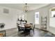 Bright dining room with a wooden table, chandelier, hardwood floors, and view of kitchen at 1015 N Beville Ave, Indianapolis, IN 46201
