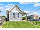 Charming home with a well-manicured lawn and inviting front porch with concrete steps at 1015 N Beville Ave, Indianapolis, IN 46201