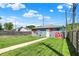 Spacious backyard featuring a garage with artistic floral mural on a sunny day at 1015 N Beville Ave, Indianapolis, IN 46201