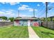 Garage featuring an artistic mural and a well-maintained lawn on a sunny day at 1015 N Beville Ave, Indianapolis, IN 46201