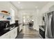 Bright, open kitchen with stainless steel appliances and a view into the dining room at 1015 N Beville Ave, Indianapolis, IN 46201