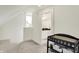 Attic conversion with carpet, baby changing table, and view to bathroom at 1015 N Beville Ave, Indianapolis, IN 46201