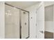Modern tiled shower featuring a glass door and sleek fixtures, conveniently located next to the closet at 1015 N Beville Ave, Indianapolis, IN 46201