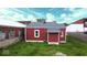 View of home exterior with red siding, white trim, and a well-maintained yard with green grass at 104 W Pearl St, Trafalgar, IN 46181