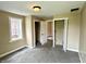 Image shows a bedroom with grey carpet and window at 104 W Pearl St, Trafalgar, IN 46181