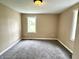 Image shows a bedroom with grey carpet and a window at 104 W Pearl St, Trafalgar, IN 46181