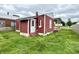Rear exterior of a single-Gathering home featuring a back door and red siding at 104 W Pearl St, Trafalgar, IN 46181
