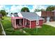 Cozy red home featuring white trim, a covered porch, and a gray roof, blending charm and functionality at 104 W Pearl St, Trafalgar, IN 46181